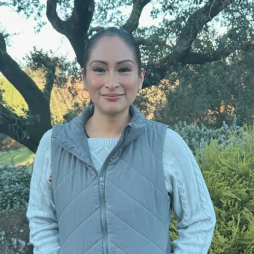 melissa wearing vest and smiling outside