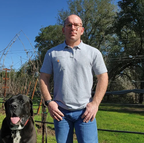 trevor with dog on vineyard